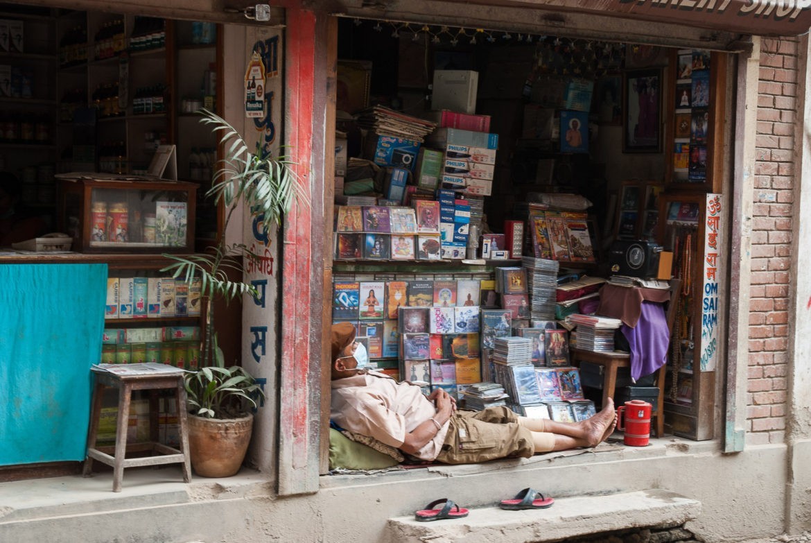Sklepikarz wypoczywający/pracujący przy swoim biznesie